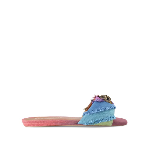 The Kurt Geiger Kensington Flat Sandal, an addition to the Kensington Collection, is crafted from a bleached denim in the iconic rainbow stripe design. The antiqued brass eagle head features crystals and black eyes on the strap.
