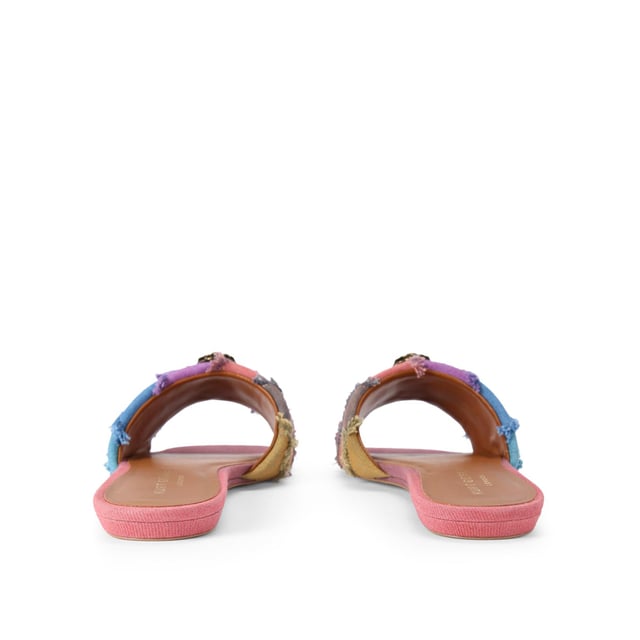 The Kurt Geiger Kensington Flat Sandal, an addition to the Kensington Collection, is crafted from a bleached denim in the iconic rainbow stripe design. The antiqued brass eagle head features crystals and black eyes on the strap.