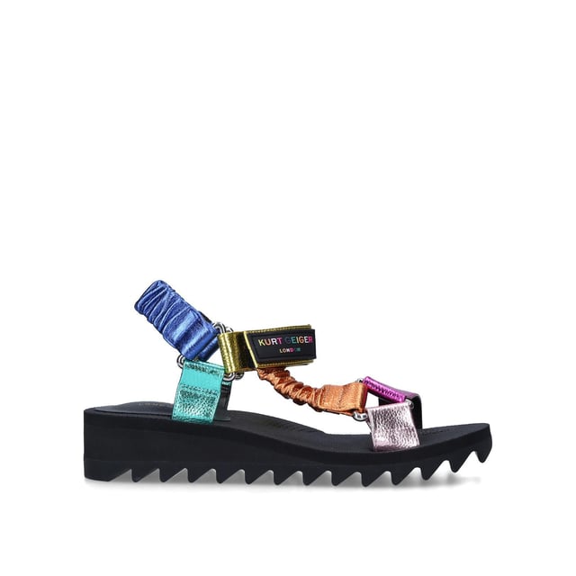 The Orion sandal is a open style with multi-colour ruched straps across the foot. The velcro strap is topped with rubber branded patch. Sole height: 4cm. Black treaded sole.
