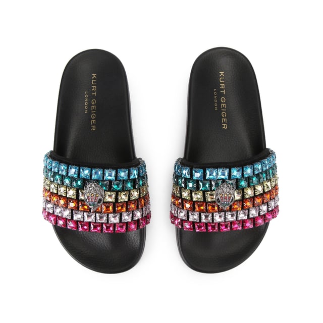 This Carvela Meena Eagle sandal slips onto the foot with a black moulded footbed. The toe strap is designed in the rainbow Kensington weave with Kurt Geiger London branding on a crystal coated canvas. There is an antiqued silver eagle head sat on top.
