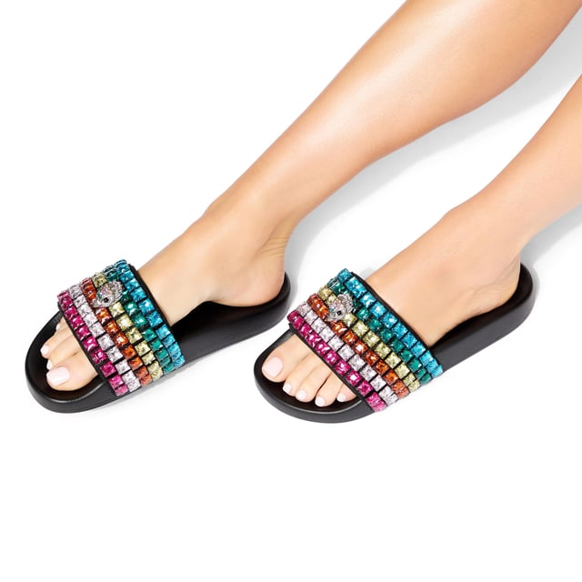 This Carvela Meena Eagle sandal slips onto the foot with a black moulded footbed. The toe strap is designed in the rainbow Kensington weave with Kurt Geiger London branding on a crystal coated canvas. There is an antiqued silver eagle head sat on top.