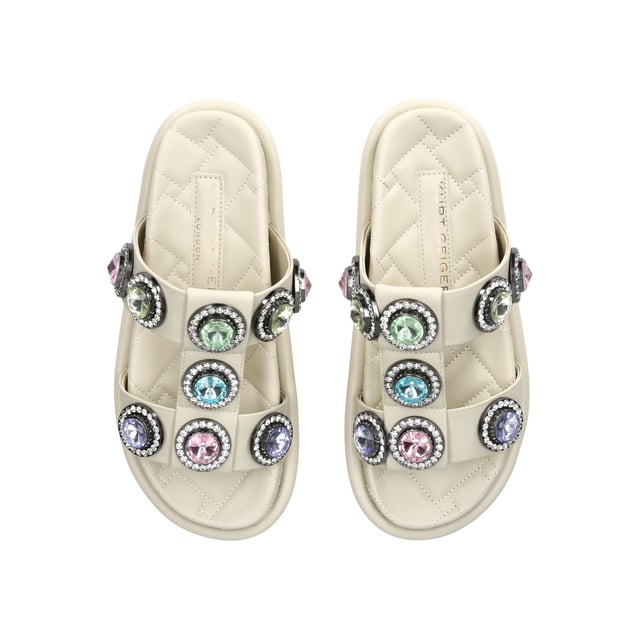 The Orson Crystal Sandal arrives in a sleek bone. The strap is topped with oversized multi-colour crystals. Overstitched quilted insole with padding, seen across the collections.