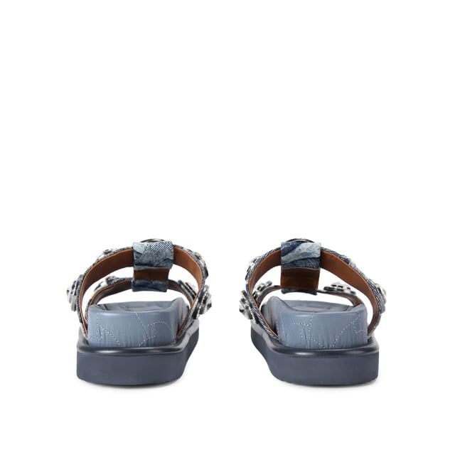 The Orson Crystal Sandal arrives in a denim fabric with quilted effect. The strap is topped with oversized crystals. Overstitched quilted insole with padding, seen across the collections.