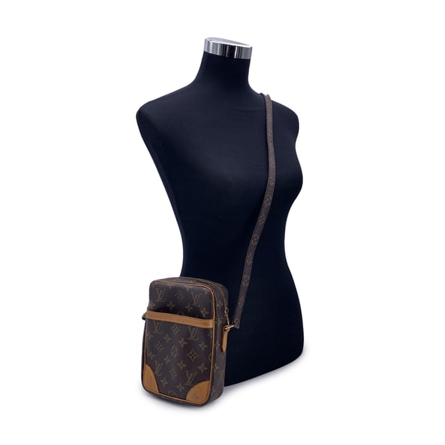 VINTAGE, RRP AS NEW
A true classic from the archives of Louis Vuitton, the Danube Messenger Bag blends compact utility with the timeless appeal of the house's iconic monogram canvas. This stylish piece is beloved by vintage collectors for its practical size, durable design, and unmistakable heritage look.  Trimmed in warm tan leather and accented with gold-tone hardware, the Danube features a convenient front slip pocket and an adjustable monogram canvas strap with a shoulder pad-designed for comfortable, on-the-go wear. The top zipper opens to a leather-lined interior with an open pocket, perfect for keeping essentials close and organized.  Inside, the embossed 'LOUIS VUITTON Paris - Made in France' mark and unique ity serial number attest to the bag's origins and craftsmanship. Compact yet functional, the Danube remains one of LV's most versatile vintage models-ideal for city explorers, seasoned travelers, or anyone seeking a piece of classic Vuitton charm with everyday practicality. Condition Rating: B - VERY GOOD CONDITIONCondition Details: Gently used. Some scratches and darkness of use on leather trim. Some darkness on the hardware. Light scratches on the internal lining. Please check the photos carefully and ask if you need to know more details or if you have any doubts.Measurements (cm):Depth: 3.8Height: 20.3Length: 15.2Other Details: Dustbag? NoKeys? NoBox? No Measurments:  width: 38 mm length: 152 mm height: 203 mm strap length: 0 mm handle drop: 0 mm