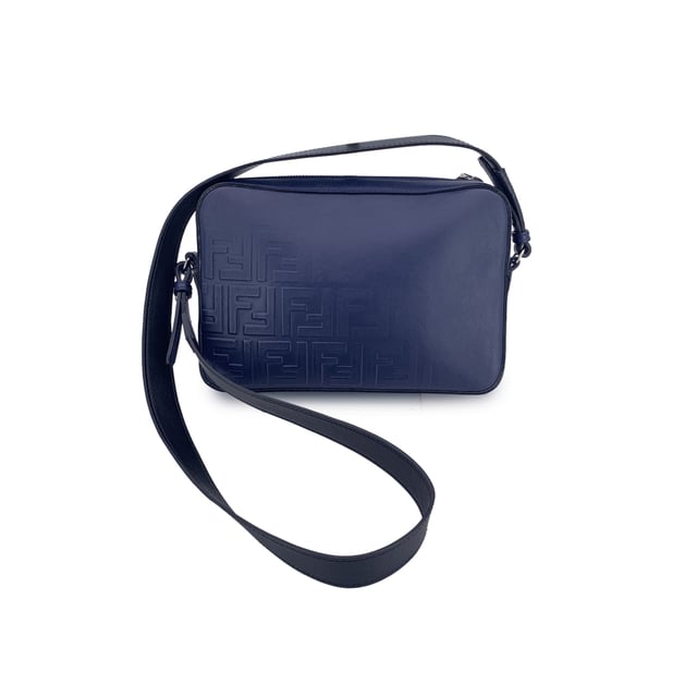 VINTAGE, RRP AS NEW
This beautiful Bag will come with a Certificate of ity provided by Entrupy. The certificate will be provided at no further cost  Step into the timeless elegance of Italian craftsmanship with this Forever Fendi Fade Camera Bag, a true tribute to the house's bold design legacy. Wrapped in rich blue leather, this crossbody tells a story of luxury reimagined for the modern collector.  The front is adorned with the iconic embossed Zucca FF logo, gracefully faded like a memory in motion - a nod to Fendi's heritage that whispers rather than shouts. The silver-tone hardware catches the light just enough to make a statement, while the sleek zip-top closure adds a practical touch to its refined silhouette.  Its single shoulder strap - a striking blend of black and blue leather - adds depth and contrast, letting the bag swing effortlessly between polished city wear and edgy street style. Inside, the black fabric lining reveals thoughtful compartments: a dedicated interior pocket paired with structured card slots for sleek organization.  A discreet 'Fendi - Made in Italy' tag sits proudly inside, with the ity serial number tucked behind - a quiet reassurance of origin for the discerning collector.  A rare find for lovers of second-hand sophistication, this camera bag is more than an accessory - it's a chapter from Fendi's evolving story, waiting to be carried forward. Condition Rating: A - EXCELLENTCondition Details: Gently used. Light scratches on the shoulder strap. Please check the photos carefully and ask if you need to know more details or if you have any doubts.Measurements (cm):Depth: 5.1Height: 15.2Length: 22.9Other Details: Dustbag? YesKeys? NoBox? No Measurments:  width: 51 mm length: 229 mm height: 152 mm strap length: 0 mm handle drop: 0 mm
