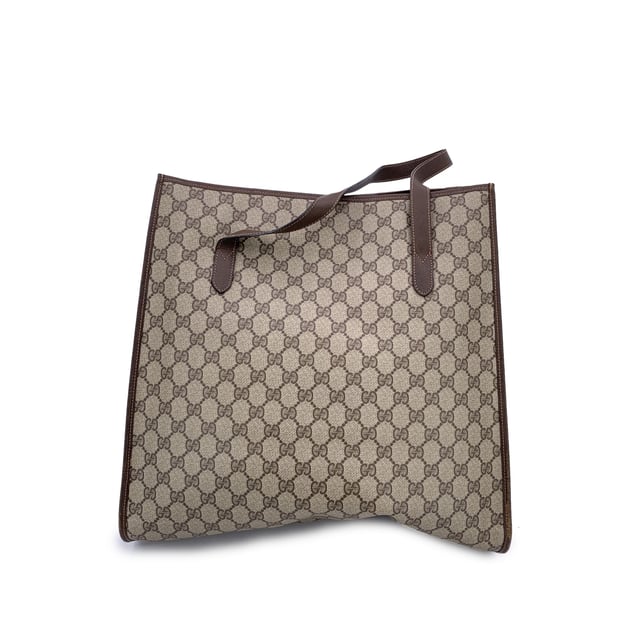 VINTAGE, RRP AS NEW
Step into the understated elegance of the past with this vintage Gucci tote bag, a refined piece from the iconic Gucci Accessory Collection. Crafted in beige monogram canvas, it proudly showcases the unmistakable GG pattern that defined an era of quiet luxury. Trimmed in rich brown genuine leather, this tote exudes both character and classic Italian craftsmanship.  The magnetic button closure opens to a beige fabric-lined interior, complete with a practical side zip pocket for your essentials. Inside, the original 'GUCCI Accessory Collection - Made in Italy' leather tag remains intact, a subtle nod to the brand's heritage and ity.  A timeless piece for those who appreciate vintage luxury with soul, this Gucci tote is more than a bag-it's a story carried on the arm. Condition Rating: B - VERY GOOD CONDITIONCondition Details: Gently used. Minimal wear of use on leather trim. A small white mark on canvas on the bottom. Please check the photos carefully and ask if you need to know more details or if you have any doubts.Measurements (cm):Depth: 11.4Height: 36.8Length: 36.8Other Details: Dustbag? NoKeys? NoBox? No Measurments:  width: 114 mm length: 368 mm height: 368 mm strap length: 0 mm handle drop: 0 mm