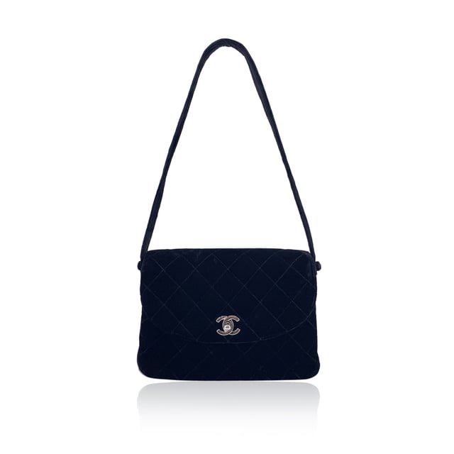 VINTAGE, RRP AS NEW
This beautiful Bag will come with a certificate of ity provided by third party ators. The certificate will be provided at no further cost  From the elegant runways of the late '90s comes this vintage Chanel single flap bag, crafted in sumptuous black quilted velvet, a texture that captures both light and attention with effortless grace. Dating from the 1996-1997 collection, this piece carries the spirit of an era when Chanel redefined quiet luxury with bold femininity.  The front flap is anchored by the iconic CC turn-lock clasp in silver-tone metal, a timeless emblem of the Maison's enduring legacy. the bag features 1 rear open pocket. Inside, the bag opens to reveal a black leather lining, elegantly divided into two main compartments, with one zippered pocket and one open side pocket - the perfect balance of form and function.  Every detail speaks to Chanel's meticulous craftsmanship, from the embossed 'CHANEL' and 'Made in France' markings inside to the discreet ity serial number that confirms its heritage.  More than a bag, this is a collector's keepsake - a velvet echo of '90s Parisian style, meant to be worn, admired, and passed on.  Condition Rating: B - VERY GOOD CONDITIONCondition Details: Gently used. The velvet on the studs that hold the shoulder strap is slightly worn. Minimal wear of use inside. Minimal wear of use on the flap, upper corner (some show arrows indicating any evident defect.). Please, see the photos and/or ask if you have any doubts or if you need more information.Measurements (cm):Depth: 8.9Height: 16.5Length: 24.1Other Details: Dustbag? YesKeys? NoBox? No Measurments:  width: 89 mm length: 241 mm height: 165 mm strap length: 0 mm handle drop: 0 mm