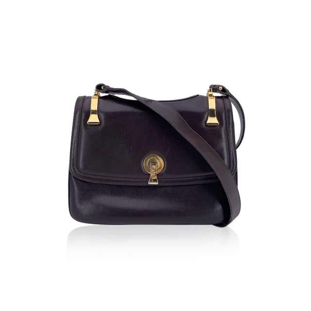 VINTAGE, RRP AS NEW
A classic from Gucci's rich leather-making legacy, this vintage brown leather shoulder bag is a quiet nod to Italian elegance. Crafted in smooth, warm-toned leather that has only grown more beautiful with time, it carries the character of decades past - where form met function with impeccable style.  The front flap features a sleek clasp closure, opening to a thoughtfully designed interior lined in matching brown leather. Inside, you'll find two main compartments, alongside a side zip pocket and a side open pocket - ideal for keeping essentials organized while on the move.  The adjustable leather shoulder strap allows for comfortable wear, whether slung casually or carried with intention. Stamped inside with 'Made in Italy by Gucci', this piece bears the unmistakable signature of quality and heritage.  Understated, refined, and deeply rooted in Gucci tradition, this shoulder bag is a timeless companion for lovers of vintage with an eye for craftsmanship. Condition Rating: B - VERY GOOD CONDITIONCondition Details: Some normal wear of use on leather (light scratches). Some light loss of gilding on the hardware. Some scratches on the internal lining. Please check the photos carefully and ask if you need to know more details or if you have any doubtsMeasurements (cm):Depth: 3.8Height: 19.1Length: 25.4Other Details: Dustbag? NoKeys? NoBox? No Measurments:  width: 38 mm length: 254 mm height: 191 mm strap length: 0 mm handle drop: 0 mm