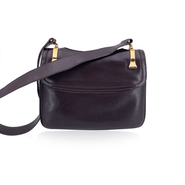 VINTAGE, RRP AS NEW
A classic from Gucci's rich leather-making legacy, this vintage brown leather shoulder bag is a quiet nod to Italian elegance. Crafted in smooth, warm-toned leather that has only grown more beautiful with time, it carries the character of decades past - where form met function with impeccable style.  The front flap features a sleek clasp closure, opening to a thoughtfully designed interior lined in matching brown leather. Inside, you'll find two main compartments, alongside a side zip pocket and a side open pocket - ideal for keeping essentials organized while on the move.  The adjustable leather shoulder strap allows for comfortable wear, whether slung casually or carried with intention. Stamped inside with 'Made in Italy by Gucci', this piece bears the unmistakable signature of quality and heritage.  Understated, refined, and deeply rooted in Gucci tradition, this shoulder bag is a timeless companion for lovers of vintage with an eye for craftsmanship. Condition Rating: B - VERY GOOD CONDITIONCondition Details: Some normal wear of use on leather (light scratches). Some light loss of gilding on the hardware. Some scratches on the internal lining. Please check the photos carefully and ask if you need to know more details or if you have any doubtsMeasurements (cm):Depth: 3.8Height: 19.1Length: 25.4Other Details: Dustbag? NoKeys? NoBox? No Measurments:  width: 38 mm length: 254 mm height: 191 mm strap length: 0 mm handle drop: 0 mm