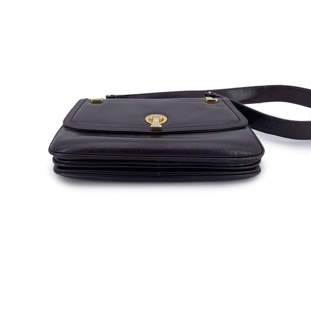 VINTAGE, RRP AS NEW
A classic from Gucci's rich leather-making legacy, this vintage brown leather shoulder bag is a quiet nod to Italian elegance. Crafted in smooth, warm-toned leather that has only grown more beautiful with time, it carries the character of decades past - where form met function with impeccable style.  The front flap features a sleek clasp closure, opening to a thoughtfully designed interior lined in matching brown leather. Inside, you'll find two main compartments, alongside a side zip pocket and a side open pocket - ideal for keeping essentials organized while on the move.  The adjustable leather shoulder strap allows for comfortable wear, whether slung casually or carried with intention. Stamped inside with 'Made in Italy by Gucci', this piece bears the unmistakable signature of quality and heritage.  Understated, refined, and deeply rooted in Gucci tradition, this shoulder bag is a timeless companion for lovers of vintage with an eye for craftsmanship. Condition Rating: B - VERY GOOD CONDITIONCondition Details: Some normal wear of use on leather (light scratches). Some light loss of gilding on the hardware. Some scratches on the internal lining. Please check the photos carefully and ask if you need to know more details or if you have any doubtsMeasurements (cm):Depth: 3.8Height: 19.1Length: 25.4Other Details: Dustbag? NoKeys? NoBox? No Measurments:  width: 38 mm length: 254 mm height: 191 mm strap length: 0 mm handle drop: 0 mm