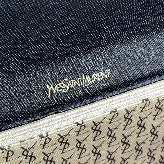 VINTAGE, RRP AS NEW
Step into timeless elegance with this Yves Saint Laurent vintage clutch bag, a true reflection of refined 1980s minimalism. Crafted in supple black leather, this piece blends classic sophistication with a subtle edge, thanks to its distinctive asymmetric flap design. The flap fastens securely with a magnetic button closure, revealing a neatly lined fabric interior complete with a side zip pocket-perfect for your essentials.  Inside, the iconic 'YVES SAINT LAURENT' name is embossed, a quiet reminder of the maison's heritage and craftsmanship. Understated yet unmistakably luxurious, this clutch is more than an accessory-it's a piece of fashion history, ready to accompany you on evenings out or cherished as part of a vintage collection. Condition Rating: A - EXCELLENTCondition Details: Gently used. Please check the photos carefully and ask if you need to know more details or if you have any doubts.Measurements (cm):Depth: 2.5Height: 17.8Length: 25.4Other Details: Dustbag? NoKeys? NoBox? No Measurments:  width: 25 mm length: 254 mm height: 178 mm strap length: 0 mm handle drop: 0 mm