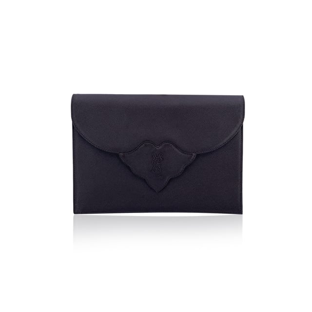 VINTAGE, RRP AS NEW
Step into timeless elegance with this vintage Yves Saint Laurent clutch bag - a true emblem of classic Parisian sophistication. Crafted in brown leather, this refined piece echoes the understated glamour of eras past. The structured silhouette is anchored by a front flap with a magnetic button closure, crowned with the iconic YSL logo - a quiet nod to one of fashion's most enduring maisons.  Open the flap to reveal a fabric-lined interior, thoughtfully designed with a side zip pocket for your evening essentials. A rear open pocket adds practicality without compromising its sleek form. Inside, the 'YVES SAINT LAURENT' embossing is a subtle reminder of its storied lineage.  Whether tucked under your arm or proudly displayed on a vanity, this vintage YSL clutch isn't just an accessory - it's a chapter of fashion history, waiting to be carried into the night. Condition Rating: A - EXCELLENTCondition Details: Gently Used. Minimal scratches on leather due to normal use. Please check the images carefully. Please ask if you need to know more details or if you have any doubts.Measurements (cm):Depth: 2.5Height: 16.5Length: 24.1Other Details: Dustbag? NoKeys? NoBox? No Measurments:  width: 25 mm length: 241 mm height: 165 mm strap length: 0 mm handle drop: 0 mm