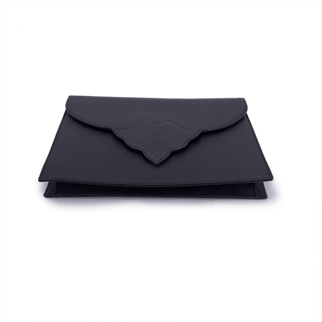 VINTAGE, RRP AS NEW
Step into timeless elegance with this vintage Yves Saint Laurent clutch bag - a true emblem of classic Parisian sophistication. Crafted in brown leather, this refined piece echoes the understated glamour of eras past. The structured silhouette is anchored by a front flap with a magnetic button closure, crowned with the iconic YSL logo - a quiet nod to one of fashion's most enduring maisons.  Open the flap to reveal a fabric-lined interior, thoughtfully designed with a side zip pocket for your evening essentials. A rear open pocket adds practicality without compromising its sleek form. Inside, the 'YVES SAINT LAURENT' embossing is a subtle reminder of its storied lineage.  Whether tucked under your arm or proudly displayed on a vanity, this vintage YSL clutch isn't just an accessory - it's a chapter of fashion history, waiting to be carried into the night. Condition Rating: A - EXCELLENTCondition Details: Gently Used. Minimal scratches on leather due to normal use. Please check the images carefully. Please ask if you need to know more details or if you have any doubts.Measurements (cm):Depth: 2.5Height: 16.5Length: 24.1Other Details: Dustbag? NoKeys? NoBox? No Measurments:  width: 25 mm length: 241 mm height: 165 mm strap length: 0 mm handle drop: 0 mm