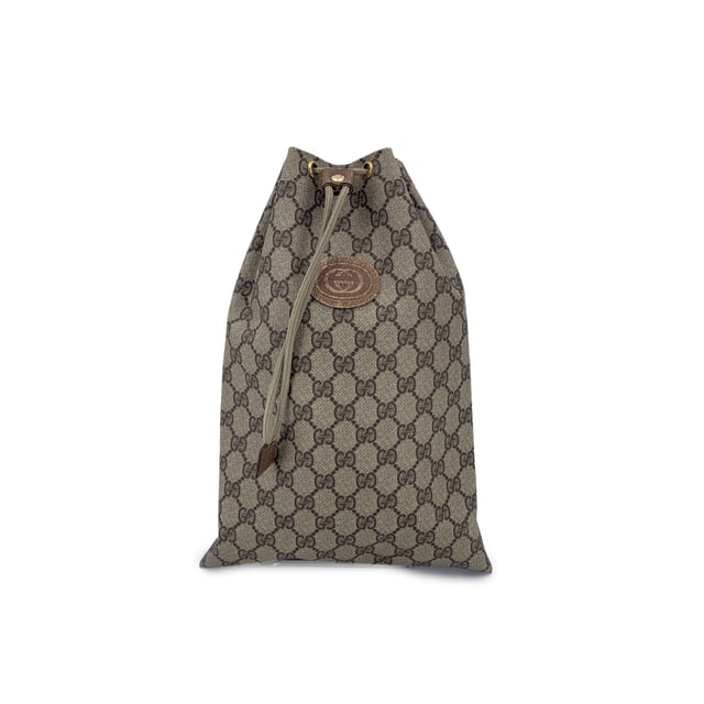 VINTAGE, RRP AS NEW
A charming relic from the golden era of Gucci, this Vintage Multipurpose Pouch is a testament to the brand's timeless appeal and practical elegance. Crafted in classic beige GG monogram canvas, it embodies the effortless style that defined the Gucci Accessory Collection-a line beloved by collectors for its functional beauty and signature flair.  The pouch features a drawstring closure, lending it a soft, relaxed silhouette while keeping your essentials secure. A GG logo patch on the front adds a subtle yet iconic touch, perfectly pairing with the understated canvas lining inside. Tucked within, the original 'Gucci Accessory Collection - Made in Italy' tag marks its vintage roots.  Compact, lightweight, and endlessly versatile, this piece is ideal as a travel companion, cosmetic holder, or casual clutch. For lovers of vintage Gucci, it's a small but storied find-full of character, charm, and history. Condition Rating: B - VERY GOOD CONDITIONCondition Details: Gently used. Light scratches on leather logo patch. Please check the photos carefully and ask if you need to know more details or if you have any doubts.Measurements (cm):Depth: n.a.Height: 33.0Length: 22.9Other Details: Dustbag? NoKeys? NoBox? No Measurments:  length: 229 mm height: 330 mm strap length: 0 mm handle drop: 0 mm