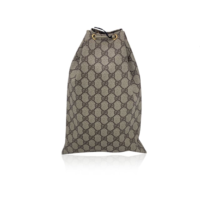 VINTAGE, RRP AS NEW
A charming relic from the golden era of Gucci, this Vintage Multipurpose Pouch is a testament to the brand's timeless appeal and practical elegance. Crafted in classic beige GG monogram canvas, it embodies the effortless style that defined the Gucci Accessory Collection-a line beloved by collectors for its functional beauty and signature flair.  The pouch features a drawstring closure, lending it a soft, relaxed silhouette while keeping your essentials secure. A GG logo patch on the front adds a subtle yet iconic touch, perfectly pairing with the understated canvas lining inside. Tucked within, the original 'Gucci Accessory Collection - Made in Italy' tag marks its vintage roots.  Compact, lightweight, and endlessly versatile, this piece is ideal as a travel companion, cosmetic holder, or casual clutch. For lovers of vintage Gucci, it's a small but storied find-full of character, charm, and history. Condition Rating: B - VERY GOOD CONDITIONCondition Details: Gently used. Light scratches on leather logo patch. Please check the photos carefully and ask if you need to know more details or if you have any doubts.Measurements (cm):Depth: n.a.Height: 33.0Length: 22.9Other Details: Dustbag? NoKeys? NoBox? No Measurments:  length: 229 mm height: 330 mm strap length: 0 mm handle drop: 0 mm