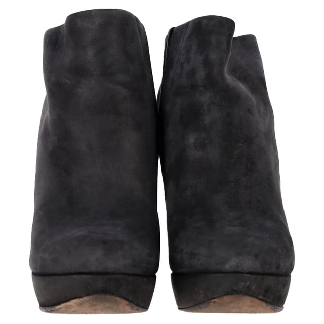VINTAGE, RRP AS NEW
 Command attention with the Balenciaga Wedge Ankle Boots in black suede, merging sleek sophistication with architectural edge. The sculptural wedge heel and soft suede finish create a bold yet refined silhouette perfect for day-to-night wear. **Style Tip:** Style them with a midi skirt and structured blazer for a chic, contemporary twist on classic tailoring.

Balenciaga Wedge Ankle Boots in Black Suede

Condition: Good
Signs of wear: Moderate signs of wear or markings, moderate scuffing insoles., Used but well maintained. Moderate creasing and marks at surface, wear at soles or replaced soles.
Packaging: None
Color: Black
Material: Suede | suede
Size: IT | 38.5
Measurements: Heel height: 125; Insole length: 255
SKU: BAPUGBSH508323W