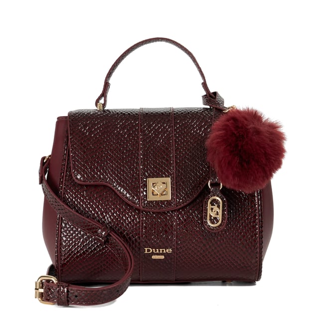 Dassios is the chic day bag that balances polish with practicality. Crafted with a contrasting textured side panel for a subtle style twist, it features a sleek turn-lock closure and a structured top handle for timeless appeal. Inside, the monogrammed lining reveals two spacious compartments ' one zipped for added security ' keeping your essentials neatly organised. Carry it by hand for a sophisticated look, or attach the optional long strap for a hands-free cross-body style. Finished with a removable logo and plush faux-fur pom-pom charm, Dassios is your go-to for effortless everyday elegance