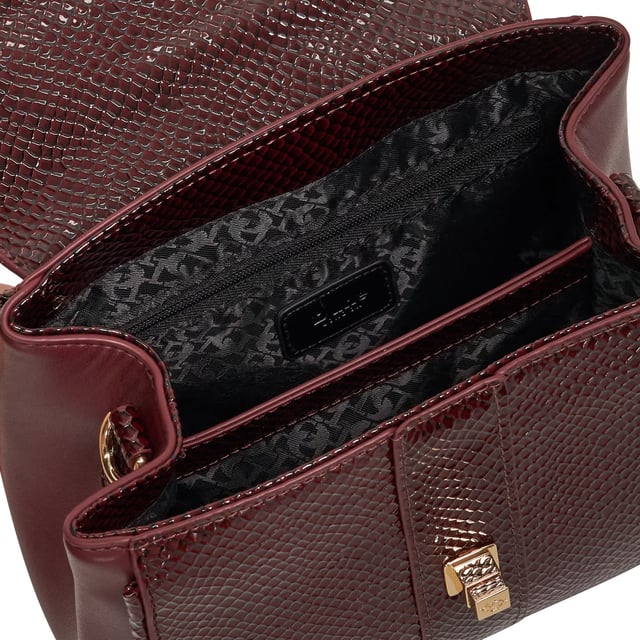 Dassios is the chic day bag that balances polish with practicality. Crafted with a contrasting textured side panel for a subtle style twist, it features a sleek turn-lock closure and a structured top handle for timeless appeal. Inside, the monogrammed lining reveals two spacious compartments ' one zipped for added security ' keeping your essentials neatly organised. Carry it by hand for a sophisticated look, or attach the optional long strap for a hands-free cross-body style. Finished with a removable logo and plush faux-fur pom-pom charm, Dassios is your go-to for effortless everyday elegance