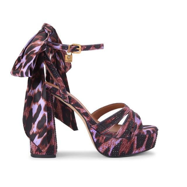 This Brixton Platform is a purple fabric which is embellished with antique brass crystal. There is a silver padlock detail and satin scarf on the ankle straps. Heel height: 11.5cm.