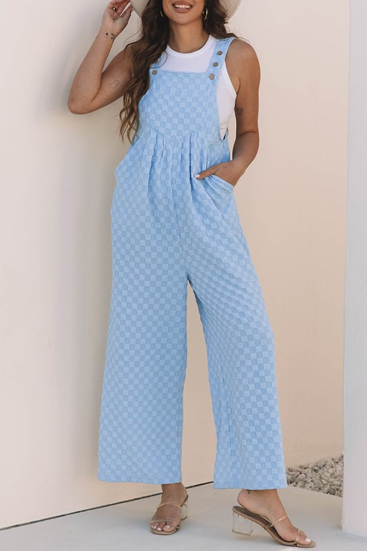 Ärmelloser Jumpsuit, entworfen für warmes Wetter  
Stilvolles karriertes Muster  
Funktionelle Latztaschen-Detail  
Hohe Taille und weit geschnittenes Bein  
Material: 95% Polyester, 5% Elastan