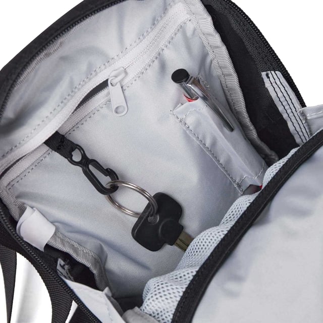 Voering: Nylon, Polyester. Hoogte: 21cm. Breedte: 15cm. Diepte: 6cm. Zakken: 1 voorzak, open zakken, 1 binnenzak, rits, pennenzakje. Compartimenten: 1 Hoofdcompartiment, Gaasvak, Ritssluiting. Verstelbare draagriemen, afneembare riem, ophanglus, interne karabijnhaak, ritstrekkers. Sluiting: Dubbele Raaksluiting.