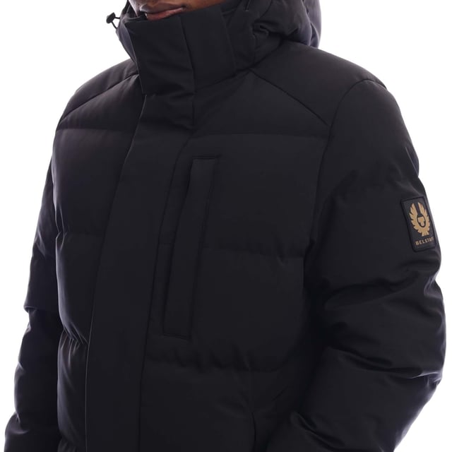 Mens Belstaff Pendulum Down Jacket in black.- Adjustable drawcord hood.- Double centre front zip fastening  snap button placket.- Two side pockets  internal pocket.- Adjustable storm cuffs with thumbholes.- Adjustable drawcord hem.- Fleece-lined chin guard.- Belstaff silicone logo on placket and cuffs  woven logo on sleeve.- Water-repellent padded.- 3-Layer Stretch Down.- 90% Polyester  10% Elastane.- Ref: 105314BLACK