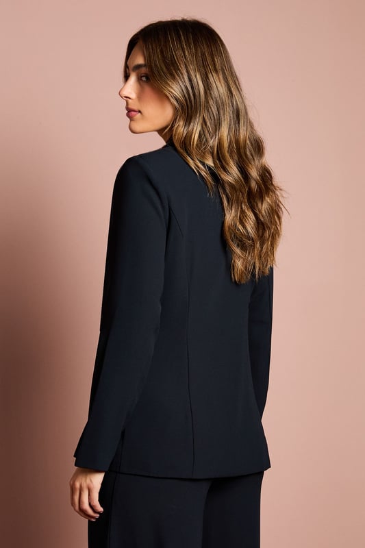 Elegant crepe blazer featuring a sophisticated drape front detail with luxurious satin trim
        Distinctive collared neckline creates a refined silhouette perfect for special occasions
        Flattering gathered waist design enhances your natural shape
        Long sleeves with structured shoulders for a polished, tailored appearance
        Versatile piece that transitions effortlessly from day to evening events
    
    Make a striking entrance at your next special occasion with this beautifully crafted Coast blazer. The standout drape front detail with satin trim creates a graceful cascade effect that adds movement and sophistication to your ensemble. Pair with the matching wide-leg trousers as shown for a contemporary take on occasion dressing that will turn heads at weddings, race days or graduation ceremonies. The structured shoulders and tailored fit create a flattering silhouette, whilst the crepe fabric offers a luxurious drape that moves elegantly with you. Complete your look with statement earrings and pointed heels for the ultimate in refined style. This versatile piece works beautifully as part of a coordinated set or can be styled with slim trousers and a camisole for a more relaxed yet equally chic approach to formal dressing.