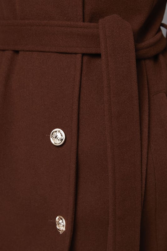 Elegant knitted collar for added sophistication
        Wrap design with button-through closure for versatile styling
        Long length offers maximum coverage and warmth
        Belted waist creates a flattering silhouette
        Functional side pockets for practicality
    
    This Wallis Knitted Collar Button Through Wrap Coat is the epitome of refined elegance. Perfect for the woman who appreciates sophistication without compromising on comfort, this coat is a versatile addition to any wardrobe. The wrap design allows for customisable fit, while the button-through closure adds a touch of classic charm. Style it over a sleek midi dress and pair with heeled boots for a polished look at formal events. For smart casual occasions, layer it over tailored trousers and a fine knit jumper, completing the ensemble with leather ankle boots. The long length and belted waist not only provide warmth but also create a striking silhouette that's sure to turn heads. Whether you're attending a business meeting or heading to a sophisticated dinner, this coat will ensure you look impeccably put-together while feeling effortlessly comfortable.
