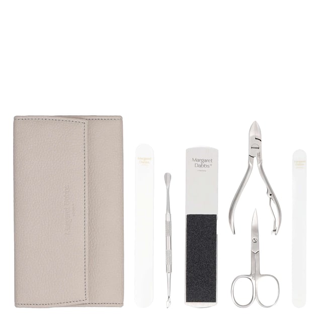 Transform your self-care routine with the Margaret Dabbs London Luxury Manicure & Pedicure Set. This exquisite collection includes essential tools such as a professional foot file, crystal nail file, super shiner buffer, cuticle pusher, nail scissors, and a curved toenail clipper, all housed in a stylish vegan leather case. Perfect for maintaining beautifully groomed hands and feet at home or while traveling, this set is a must-have for any beauty enthusiast. A thoughtful gift that combines luxury and practicality, ensuring cherished moments of pampering for years to come.