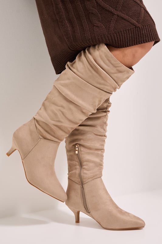 Wide fit design for enhanced comfort and roomier fit around the calf
        Elegant ruched detailing creates a relaxed, slouchy texture throughout the boot shaft
        Practical side zip fastening for easy wear
        Comfortable kitten heel measuring between 2.5-4.5cm in height
        Soft faux suede finish with a pointed toe silhouette
    
    These Dorothy Perkins Khloe knee-high boots combine practicality with on-trend style. The ruched detailing adds texture and interest whilst the modest kitten heel offers all-day wearability without sacrificing elegance. Perfect for casual daywear, these boots pair beautifully with knitted dresses as shown, or style with skinny jeans and an oversized jumper for weekend brunches with friends. The wide fit design ensures comfort for all-day wear, whilst the versatile knee-high length works wonderfully for autumn through winter. Ideal for family gatherings or coffee dates, these boots offer the perfect balance of comfort and style for the woman who wants to look fashionable without compromising on practicality. The pointed toe adds a touch of sophistication to this everyday essential.