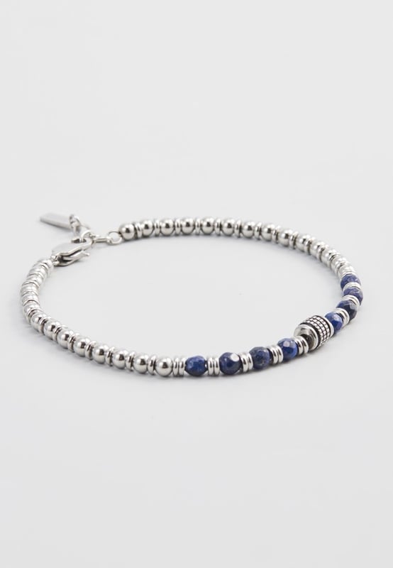 20 cm lange roestvrijstalen armband met lapis lazuli-stenen en stalen stoppers. Gepersonaliseerd label met logo.