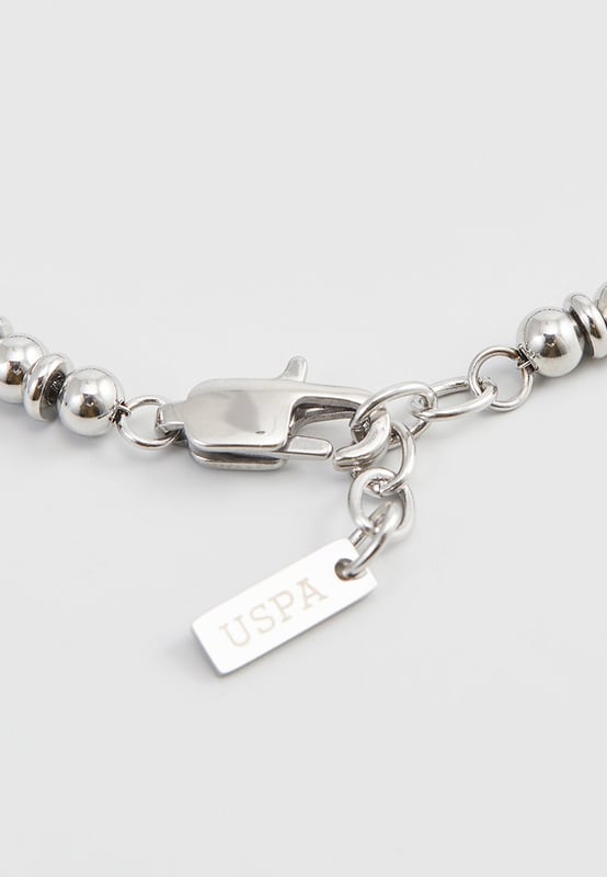 20 cm lange roestvrijstalen armband met lapis lazuli-stenen en stalen stoppers. Gepersonaliseerd label met logo.