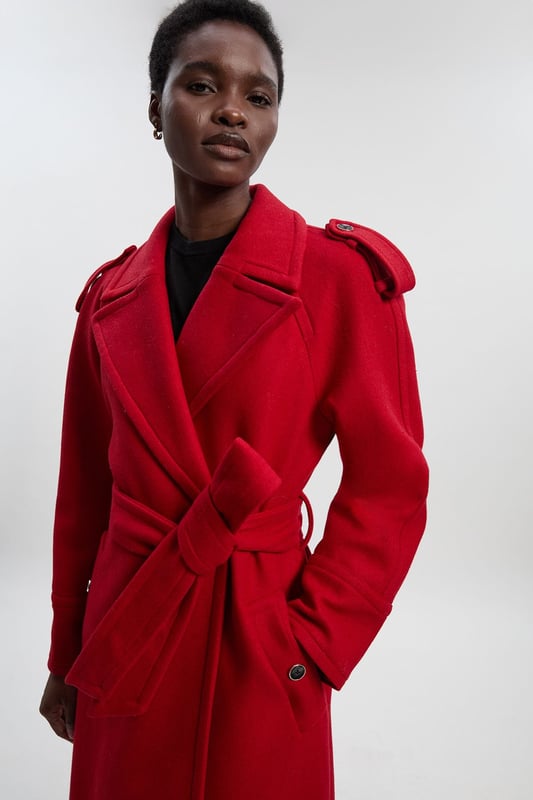 This sophisticated Karen Millen coat combines classic tailoring with contemporary styling for a versatile outerwear option. The belted waist creates a flattering shape that can be cinched or worn more relaxed. The substantial wool blend fabric provides warmth without bulk, making it ideal for autumn through winter wear. Perfect for casual work days or weekend plans, this coat will quickly become your go-to for elevating everyday ensembles. The timeless design ensures it will remain a wardrobe staple for years to come, easily dressed up with boots or down with trainers for truly versatile styling.  Tailored midi coat with elegant belted waist Structured shoulder detailing with decorative epaulettes Classic double-breasted design with statement buttons Wide notched lapels Practical side pockets