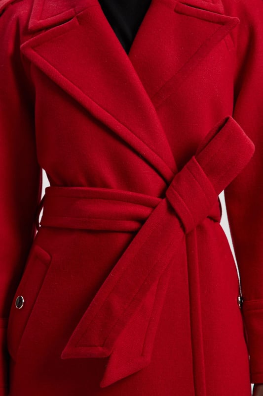 This sophisticated Karen Millen coat combines classic tailoring with contemporary styling for a versatile outerwear option. The belted waist creates a flattering shape that can be cinched or worn more relaxed. The substantial wool blend fabric provides warmth without bulk, making it ideal for autumn through winter wear. Perfect for casual work days or weekend plans, this coat will quickly become your go-to for elevating everyday ensembles. The timeless design ensures it will remain a wardrobe staple for years to come, easily dressed up with boots or down with trainers for truly versatile styling.  Tailored midi coat with elegant belted waist Structured shoulder detailing with decorative epaulettes Classic double-breasted design with statement buttons Wide notched lapels Practical side pockets