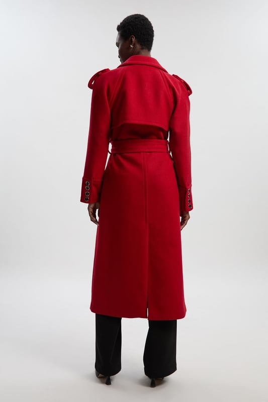 This sophisticated Karen Millen coat combines classic tailoring with contemporary styling for a versatile outerwear option. The belted waist creates a flattering shape that can be cinched or worn more relaxed. The substantial wool blend fabric provides warmth without bulk, making it ideal for autumn through winter wear. Perfect for casual work days or weekend plans, this coat will quickly become your go-to for elevating everyday ensembles. The timeless design ensures it will remain a wardrobe staple for years to come, easily dressed up with boots or down with trainers for truly versatile styling.  Tailored midi coat with elegant belted waist Structured shoulder detailing with decorative epaulettes Classic double-breasted design with statement buttons Wide notched lapels Practical side pockets