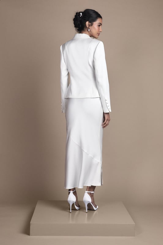 Elegant fitted skirt with luxurious satin detailing for a sophisticated bridal aesthetic
        Flattering midi length with a contemporary side split for graceful movement
        Sleek silhouette that contours to your figure with a subtle flare towards the hem
        Versatile design that pairs beautifully with the matching tailored jacket for a complete bridal ensemble
        Thoughtful construction with a comfortable stretch element for ease of wear throughout your special day
    
    This exquisitely crafted fitted skirt from Coast embodies timeless bridal elegance with modern sensibility. The refined satin detailing adds a subtle lustre to the structured silhouette, while the contemporary side split ensures you can move with grace and poise throughout your wedding celebrations. Style with the coordinating tailored jacket for a sophisticated bridal look that reflects classic tailoring with a contemporary twist. For a complete ensemble, pair with delicate strappy heels and a clutch bag as shown. The midi length offers a refined alternative to traditional bridal wear, making it perfect for registry ceremonies, intimate weddings, or as a stunning outfit change for evening receptions. This versatile piece transitions beautifully from the ceremony to celebration, ensuring you feel confident and elegant on your most treasured day.