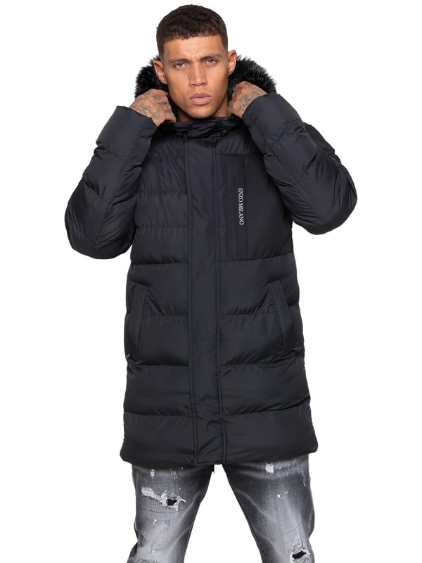 Stay warm and protected with the Enzo Milano Men’s Longline Puffer Jacket, crafted from smooth water-resistant poly fabric and insulated with synthetic fill for lasting comfort. Designed with a detachable faux fur trim and a faux fur-lined hood. The chest print and signature metal badge on the arm add premium detailing, while multiple zip pockets – including waist, chest, and inner options – keep your essentials secure. A drawcord hood with adjustable toggle, ribbed cuffs, and a full zip fastening with popper buttons provide extra protection against wind and rain, making this longline puffer your ultimate cold-weather essential.