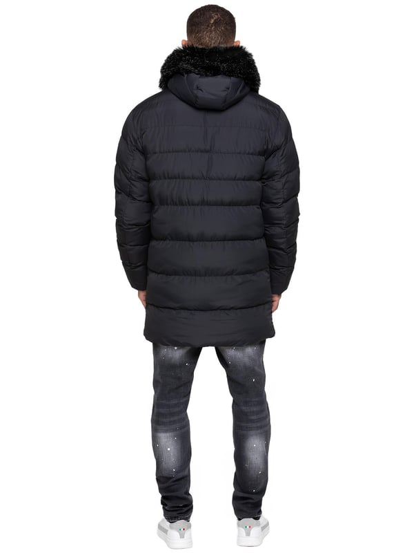 Stay warm and protected with the Enzo Milano Men’s Longline Puffer Jacket, crafted from smooth water-resistant poly fabric and insulated with synthetic fill for lasting comfort. Designed with a detachable faux fur trim and a faux fur-lined hood. The chest print and signature metal badge on the arm add premium detailing, while multiple zip pockets – including waist, chest, and inner options – keep your essentials secure. A drawcord hood with adjustable toggle, ribbed cuffs, and a full zip fastening with popper buttons provide extra protection against wind and rain, making this longline puffer your ultimate cold-weather essential.