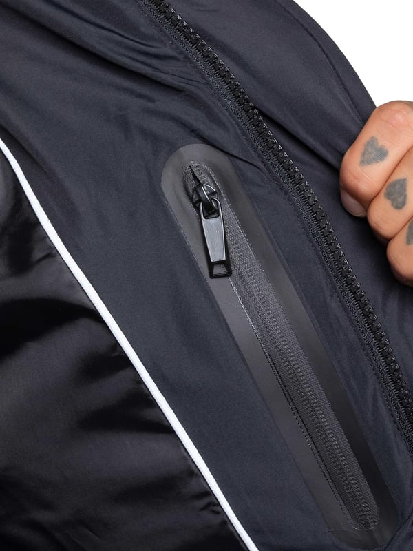 Stay warm and protected with the Enzo Milano Men’s Longline Puffer Jacket, crafted from smooth water-resistant poly fabric and insulated with synthetic fill for lasting comfort. Designed with a detachable faux fur trim and a faux fur-lined hood. The chest print and signature metal badge on the arm add premium detailing, while multiple zip pockets – including waist, chest, and inner options – keep your essentials secure. A drawcord hood with adjustable toggle, ribbed cuffs, and a full zip fastening with popper buttons provide extra protection against wind and rain, making this longline puffer your ultimate cold-weather essential.