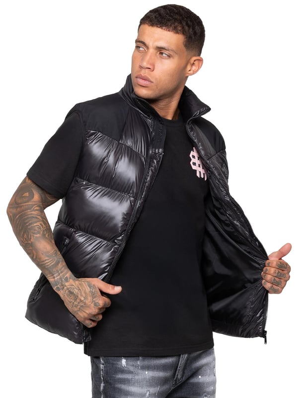 Heben Sie Ihre outerwear mit dem Enzo Milano Herren Puffer-Gilet hervor, das sowohl für Stil als auch für Praktikabilität entworfen wurde. Mit einem gestickten Enzo Milano-Logo am Reißverschluss-Schutz und einem eleganten Metallabzeichen auf der Brust bietet dieses Gilet einen Hauch von Luxus. Es wurde mit Blick auf Funktionalität gebaut und verfügt über zwei sichere seitliche Reißverschlusstaschen sowie eine einzelne Innentasche mit Reißverschluss, um Ihre Essentials sicher aufzubewahren. Der Kordelzug-Saum mit verstellbarem Stopper sorgt für eine individuelle Passform, während die glänzende Oberfläche ihm ein modernes, auffälliges Aussehen verleiht.