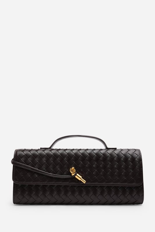 The Petal Envelope Style Woven Clutch Bag brings a chic woven texture and sleek envelope flap together in a timeless design. Made from durable faux leather, it’s compact yet practical, with enough room for your essentials. Finished with a slim handle and detachable strap, it can be styled as a clutch or worn over the shoulder—perfect for evenings out or special occasions. Key Features: • Material: Faux leather with woven finish • Dimensions: Compact envelope size • Fastening: Flap closure • Detail: Slim handle and detachable strap for versatile wear