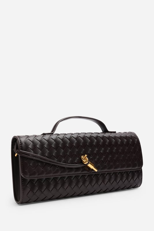 The Petal Envelope Style Woven Clutch Bag brings a chic woven texture and sleek envelope flap together in a timeless design. Made from durable faux leather, it’s compact yet practical, with enough room for your essentials. Finished with a slim handle and detachable strap, it can be styled as a clutch or worn over the shoulder—perfect for evenings out or special occasions. Key Features: • Material: Faux leather with woven finish • Dimensions: Compact envelope size • Fastening: Flap closure • Detail: Slim handle and detachable strap for versatile wear