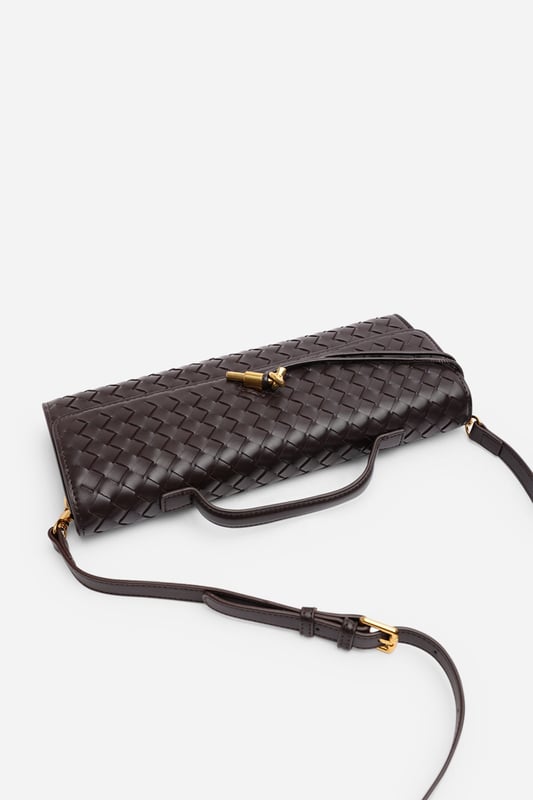 The Petal Envelope Style Woven Clutch Bag brings a chic woven texture and sleek envelope flap together in a timeless design. Made from durable faux leather, it’s compact yet practical, with enough room for your essentials. Finished with a slim handle and detachable strap, it can be styled as a clutch or worn over the shoulder—perfect for evenings out or special occasions. Key Features: • Material: Faux leather with woven finish • Dimensions: Compact envelope size • Fastening: Flap closure • Detail: Slim handle and detachable strap for versatile wear