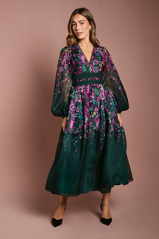 Introducing our stunning dress, crafted from a delightful organza that exudes elegance and charm. The dress features long sleeves, with lace trims.  Made from high-quality print organza, it offers a lightweight and comfortable feel. With its midi lengtha and v neck, this dress is perfect for any occasion, whether it's a wedding or a special birthday. Embrace the beauty of the floral print and make a statement wherever you go with this fabulous dress.