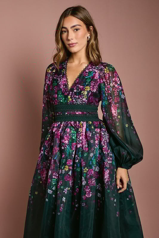 Introducing our stunning dress, crafted from a delightful organza that exudes elegance and charm. The dress features long sleeves, with lace trims.  Made from high-quality print organza, it offers a lightweight and comfortable feel. With its midi lengtha and v neck, this dress is perfect for any occasion, whether it's a wedding or a special birthday. Embrace the beauty of the floral print and make a statement wherever you go with this fabulous dress.