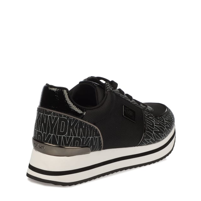 They feature a black and white design with a printed logo pattern and a platform wedge sole. Lace up fastening.Lightly padded insole.Rubber sole.