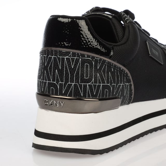 They feature a black and white design with a printed logo pattern and a platform wedge sole. Lace up fastening.Lightly padded insole.Rubber sole.