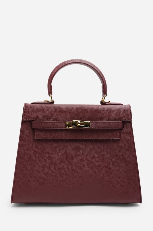 Elevate your everyday ensemble with this Lluvia Top Handle Satchel Mini Tote Bag, a timeless choice for modern elegance. Featuring a structured silhouette and refined grain-textured finish, this handbag blends style and practicality effortlessly. The polished gold-tone turn-lock closure adds a touch of sophistication. Ideal for work or weekend outings, it’s compact yet roomy enough for your essentials. Key Features: • Material: Textured faux leather with contrast stitching • Dimensions: 25cm (L) x 20cm (H) x 11cm (W) • Fastening: Gold-tone turn-lock flap closure • Detail: Minimalist top handle design with structured base and sleek finish