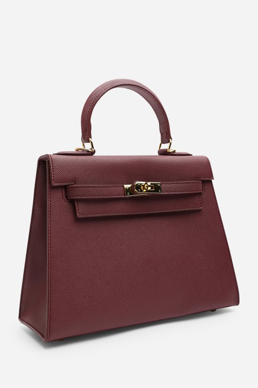 Elevate your everyday ensemble with this Lluvia Top Handle Satchel Mini Tote Bag, a timeless choice for modern elegance. Featuring a structured silhouette and refined grain-textured finish, this handbag blends style and practicality effortlessly. The polished gold-tone turn-lock closure adds a touch of sophistication. Ideal for work or weekend outings, it’s compact yet roomy enough for your essentials. Key Features: • Material: Textured faux leather with contrast stitching • Dimensions: 25cm (L) x 20cm (H) x 11cm (W) • Fastening: Gold-tone turn-lock flap closure • Detail: Minimalist top handle design with structured base and sleek finish