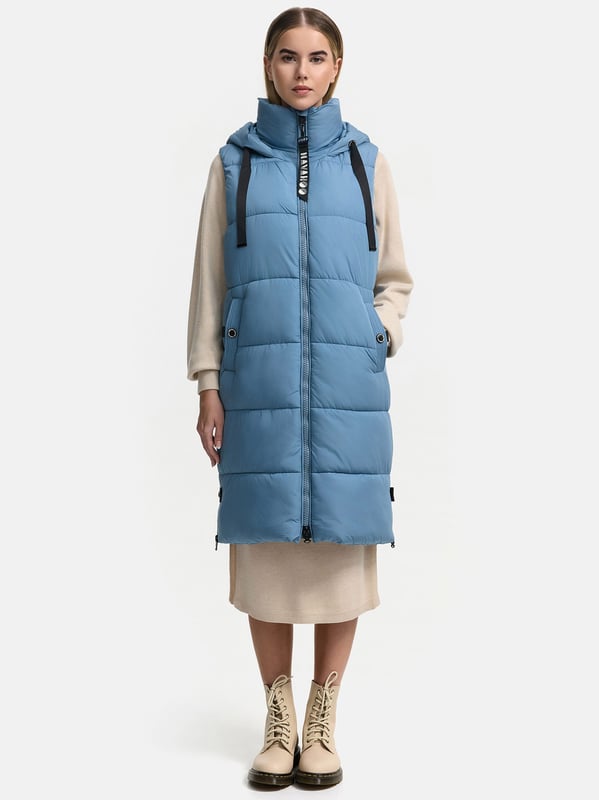 Die lange Damen Steppweste Schnuffelchen von Navahoo kombiniert Funktionalität und modisches Design. Mit weichem Fleecefutter, wasserabweisendem Obermaterial und wärmender Wattierung ist sie ideal für Frühjahr und Herbst. Die Länge bis zu den Knien und der gerade Schnitt ermöglichen das Tragen auch über dickeren Pullovern. Eine große, verstellbare Kapuze mit breitem Kordelzug sowie praktische Taschen runden das Design ab. Seitliche Gehschlitze mit Reißverschluss sorgen für Bewegungsfreiheit. Perfekte Passform, hohe Qualität und modernes Steppdesign.
Material: Oberstoff, Futter & Wattierung 100% Polyester